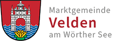 Logo Velden am Wörthersee Logo der Marktgemeinde Velden am Wörthersee. Ein grauer Schlossbogen auf rotem Hintergrund mit einer Seerose davor.